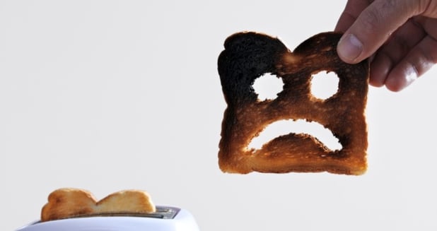 Burnt toast with a sad face to display Facebook Marketing mistakes